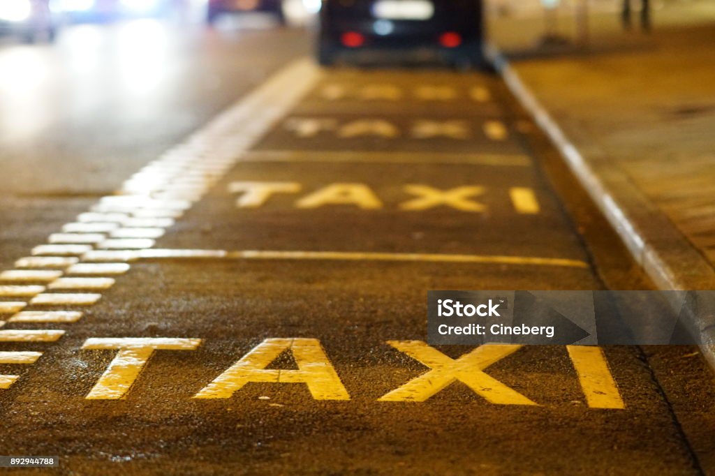 Taxi sign on asphalt